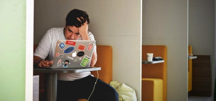 Man Thinking While Looking at Laptop