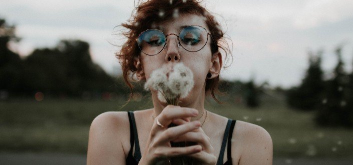 woman blowing her flowers