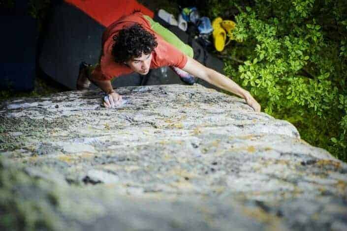 Man climbing a tall rock