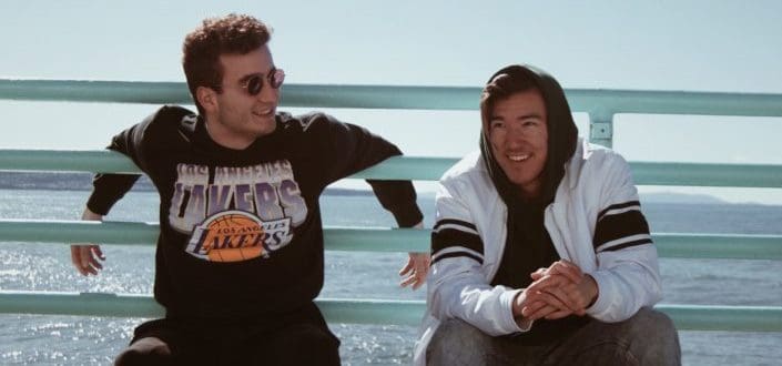 Two guys chilling and talking to each other under the sunny and windy weather