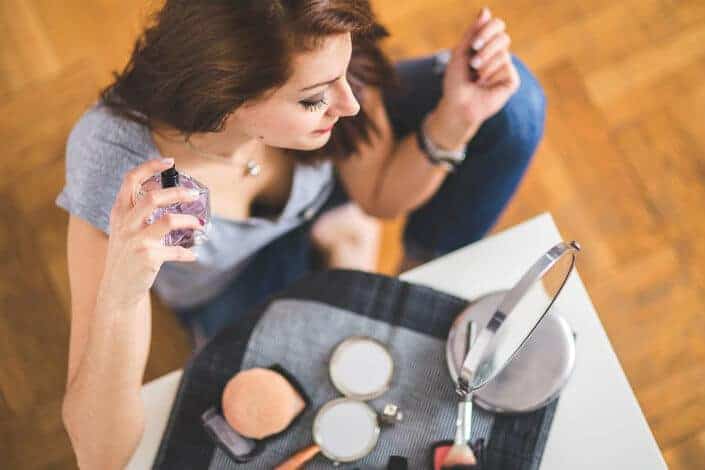 Woman spraying perfume