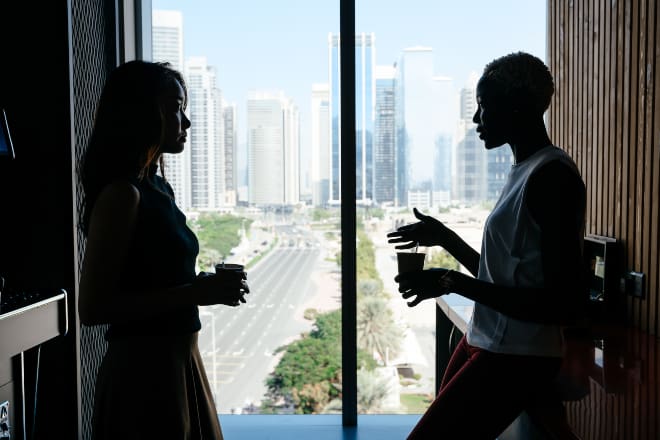 Multiethnic women talking about business project in modern office - deep conversation starters -main