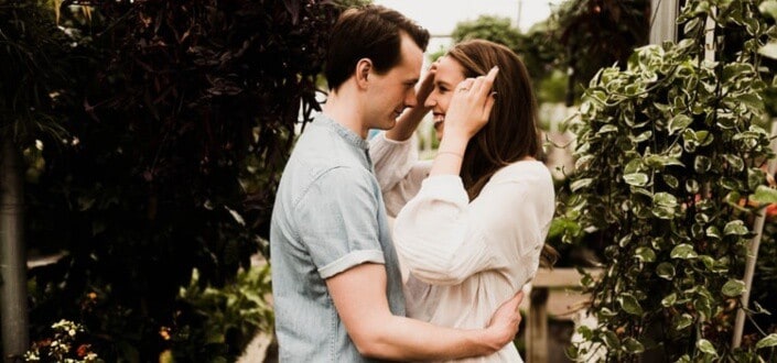 Guy hugging smiling woman