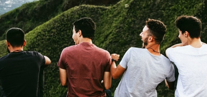 Group of guys hanging out in hilly mountainside