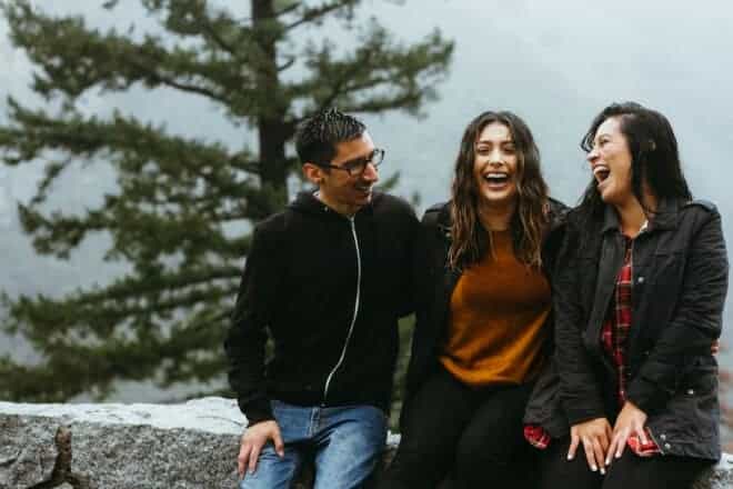 Three friends hanging out at a ledge - Funny Questions To Ask