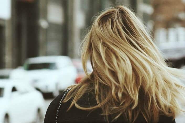 blonde hair woman walking in street