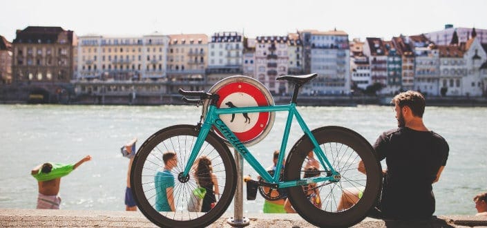 Man sitting beside his bicycle