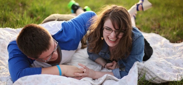 Two Person Laying on White Mat