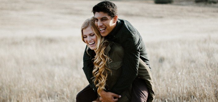 woman giving man piggyback ride