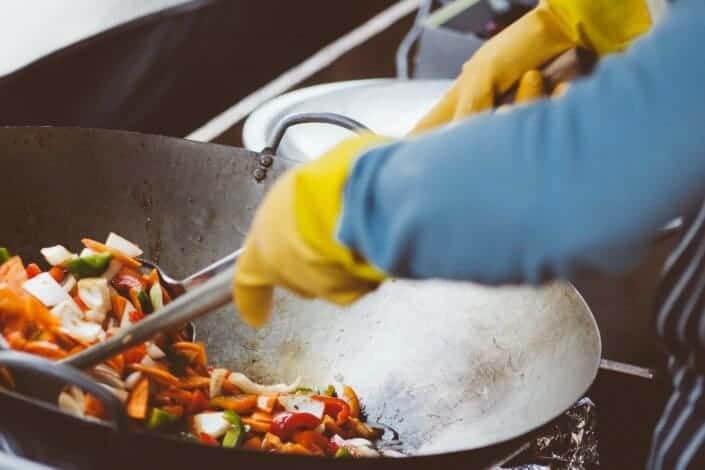 person mixing vegetable