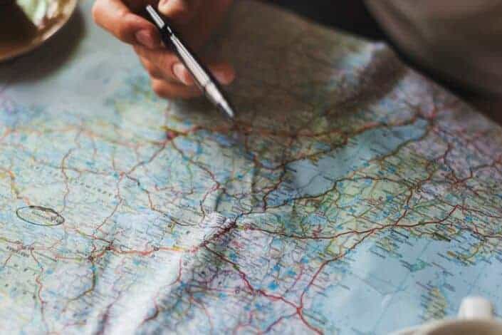 man marking location with his map