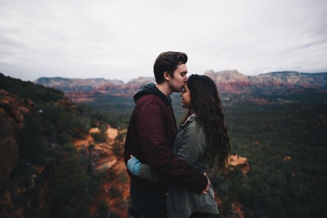 man kissing woman's forehead - Would you rather questions for couples