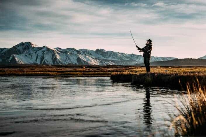 man fishing on lake