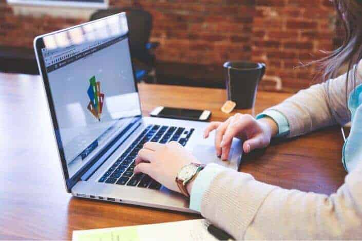 Woman working with her laptop paired with coffee