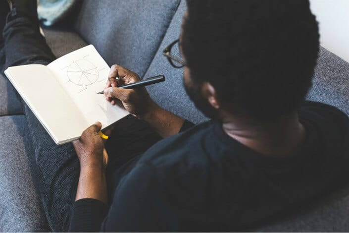 man with glasses solving math problems