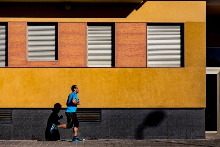 man in blue shirt running