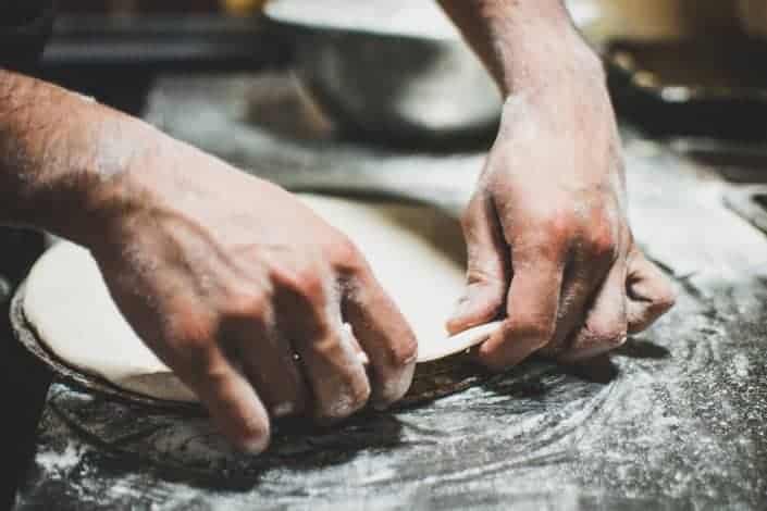 person making pizza