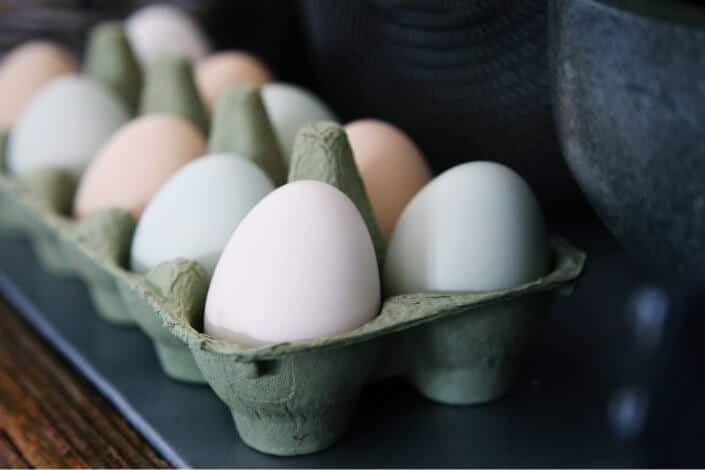 white and beige eggs on a tray 