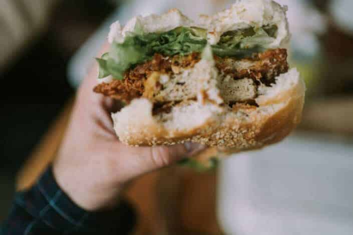 person holding hamburger 