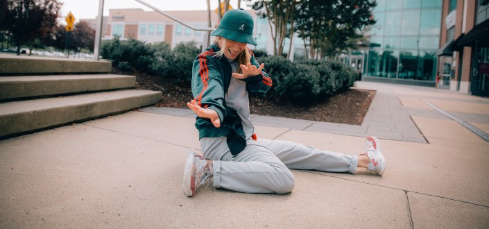 A girl doing some stunts on the pavement.