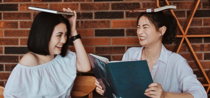 Two Women Playing with Books