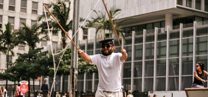 Man Holding Two Sticks