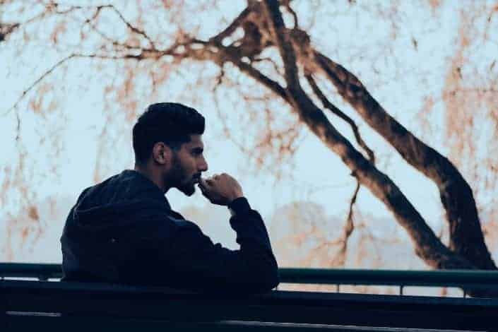 Man sitting on a bench, thinking.