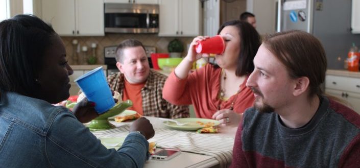 Diverse friends finished eating at home