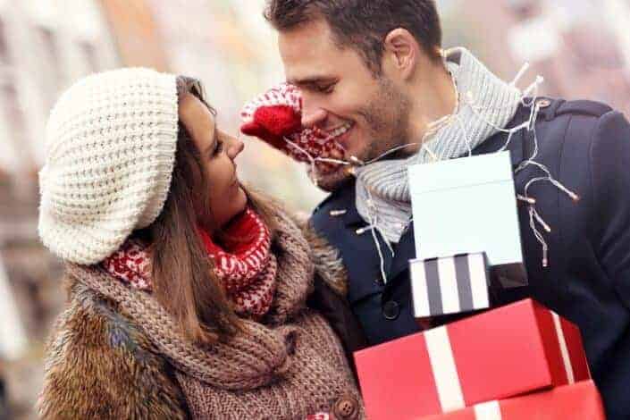 man holding gifts for his girlfriend