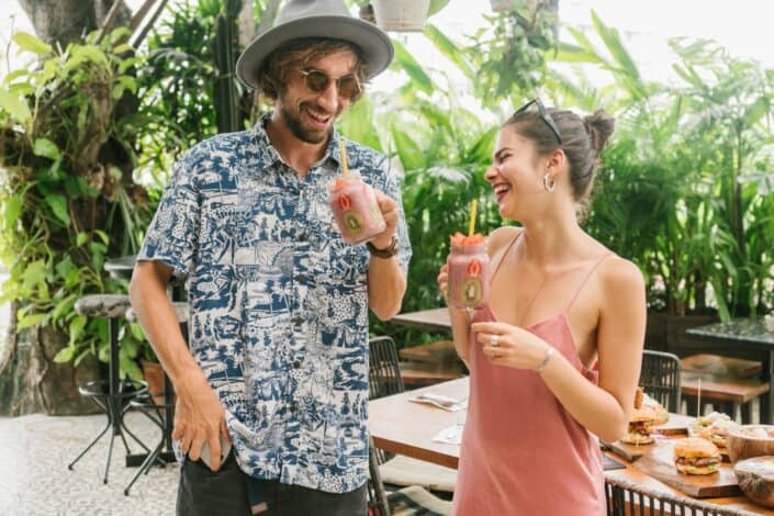 Couple drinking some smoothie on a cafeteria