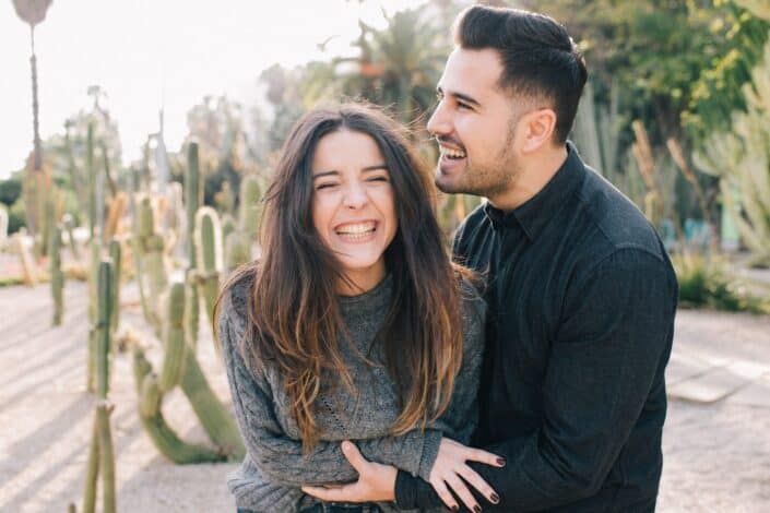 Couple giggling while in the park