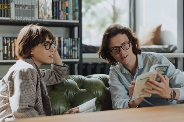 woman-in-gray-sweater-sitting-on-green-couch-pexels