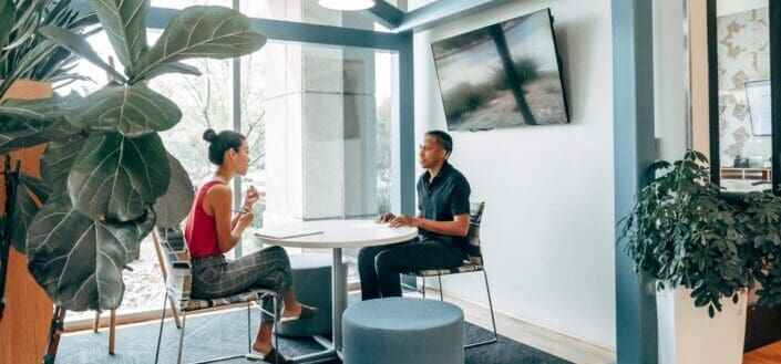 a-man-and-woman-sitting-on-the-chair-while-looking-at-each-other-pexels