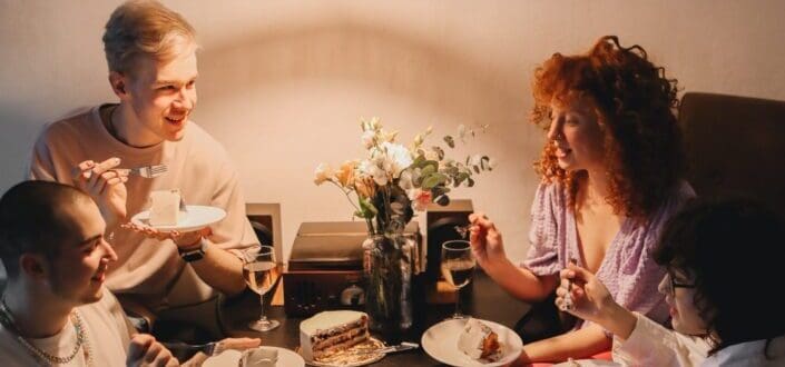 a-group-of-friends-eating-cake-while-having-conversation-