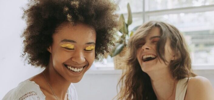 women-laughing-at-a-photograph