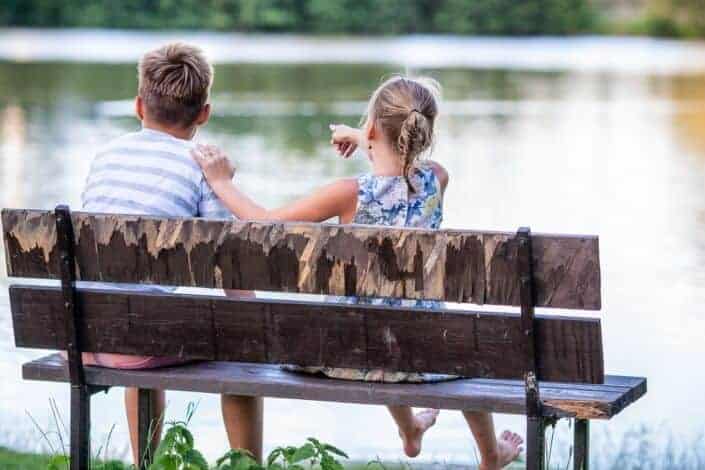 Girl and boy sitting on a bench
