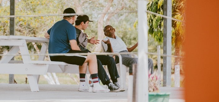 three men talking to each other