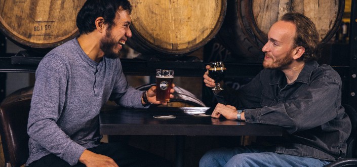 two friends laughing over drinks