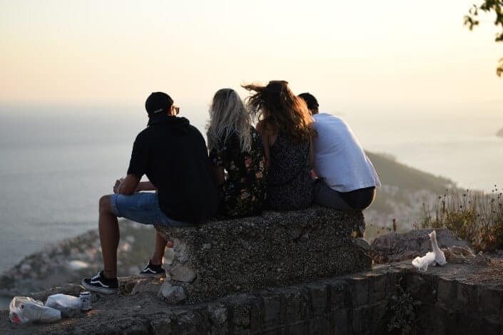 People sitting on a cliff