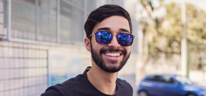 Man wearing sunglasses smiling at camera