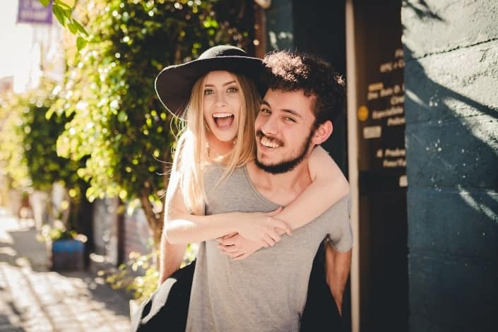 Girl riding on the back of a guy