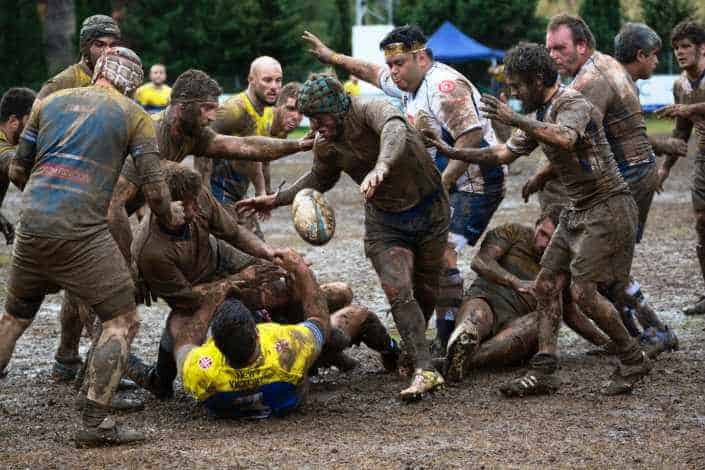 Group of guys playing mud football