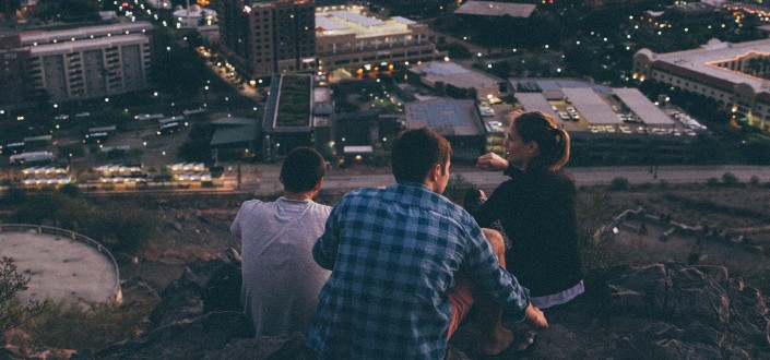 three people overlooking the city