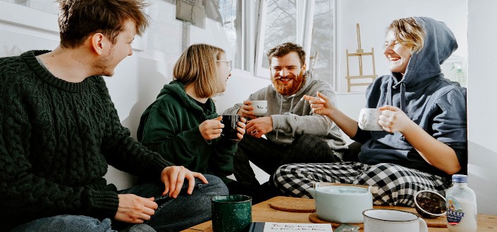 four friends drinking coffee and tea
