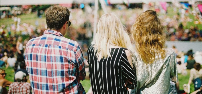 Three people standing in the park