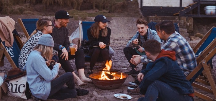 friends exchanging stories over a campfire