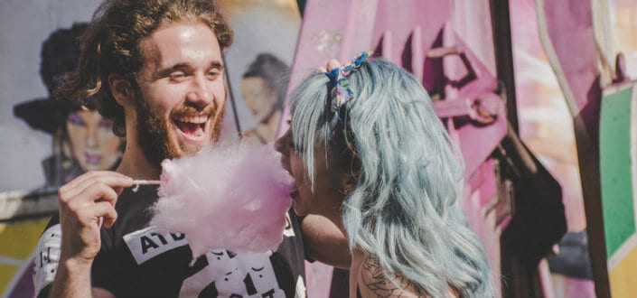 Man letting his girl eat cotton candy