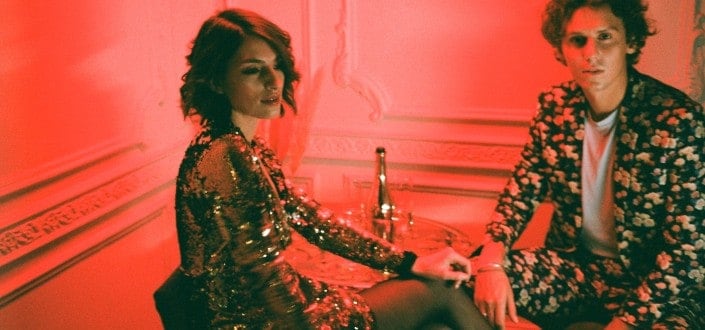Couple on a red room drinking wine