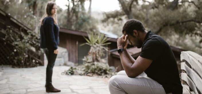 woman-looking-at-the-stressed-man-