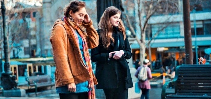 Two ladies walking along the streets